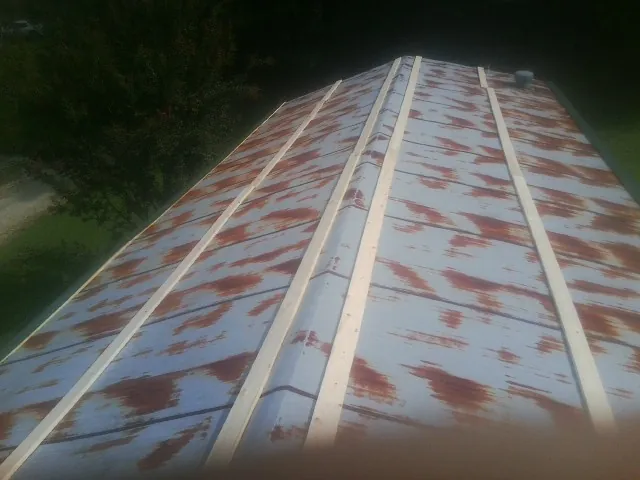 Rusted metal roof panels with new wood purlins before replacement — Storm Damage Roof Repair in Boligee by Roofing Brothers
